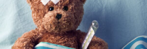 bear in bed with thermometer and plaster